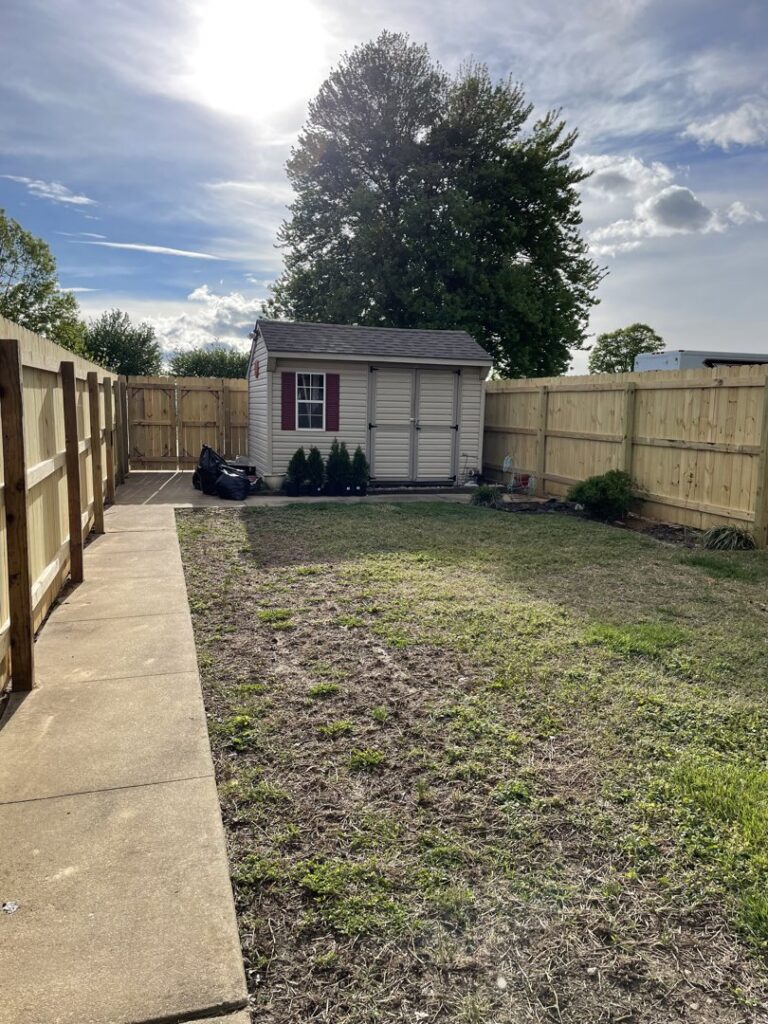 A wooden privacy fence enclosing a residential backyard with a shed, installed by DZS Fencing, LLC in Red Lion, PA.