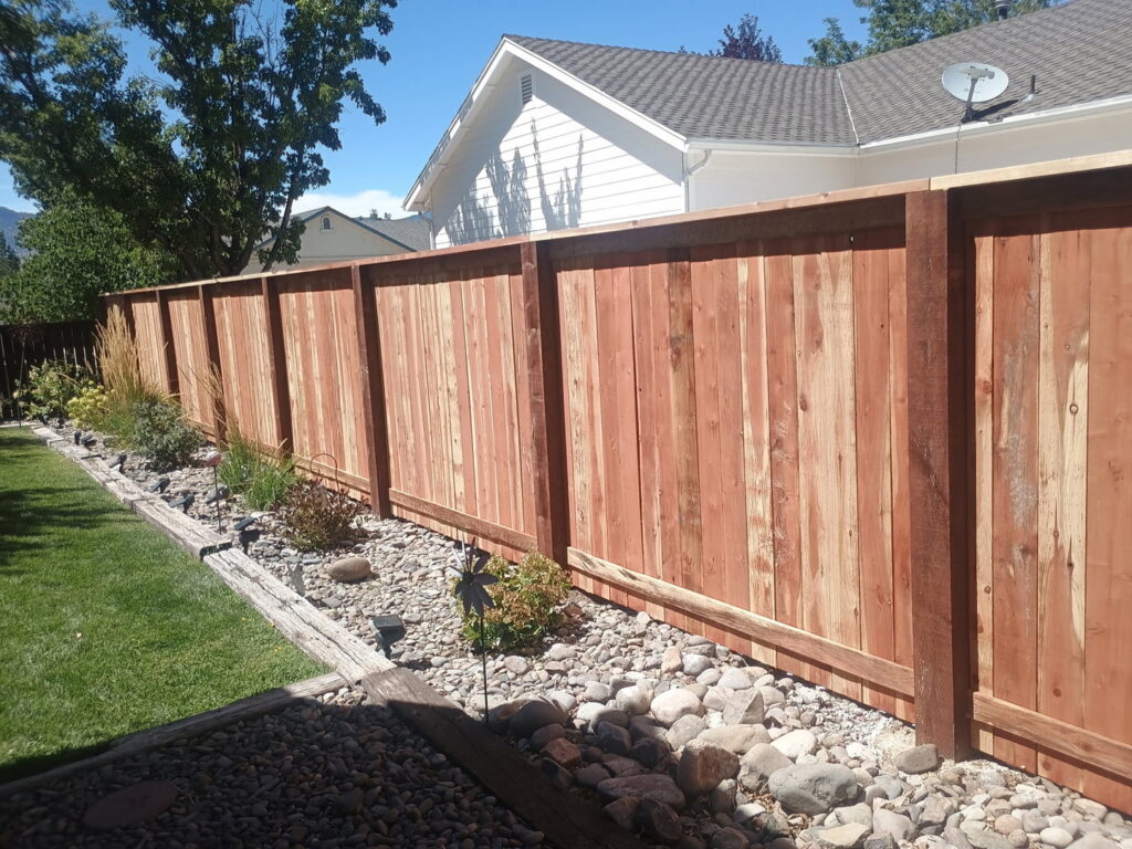 A beautiful wooden privacy fence enhancing a backyard with decorative landscaping by Finest Fence in Simi Valley, CA.