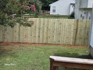 A wooden privacy fence installed in a residential backyard by Sunrise Fences in Monroe, NC.