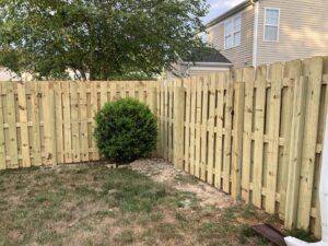 A newly installed wooden privacy fence enclosing a backyard by Sunrise Fences in Monroe, NC.