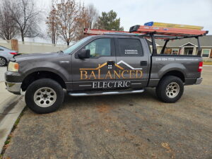 The service truck for Balanced Electric LLC, featuring their logo and contact information, in Caldwell, ID.