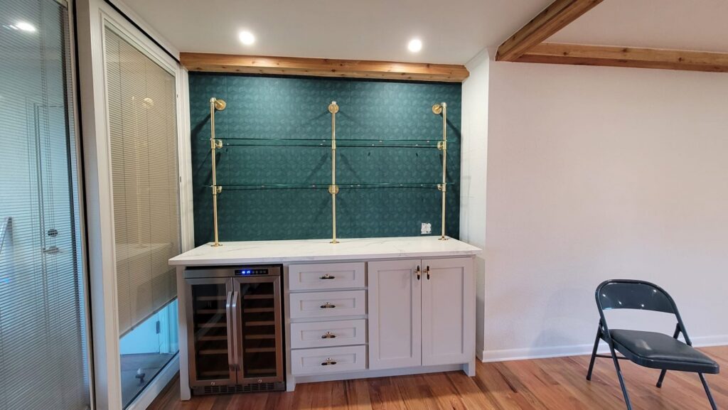 Custom bar area with under-shelf lighting and wine fridge installed by AVA Electric, LLC in Fort Worth, TX.