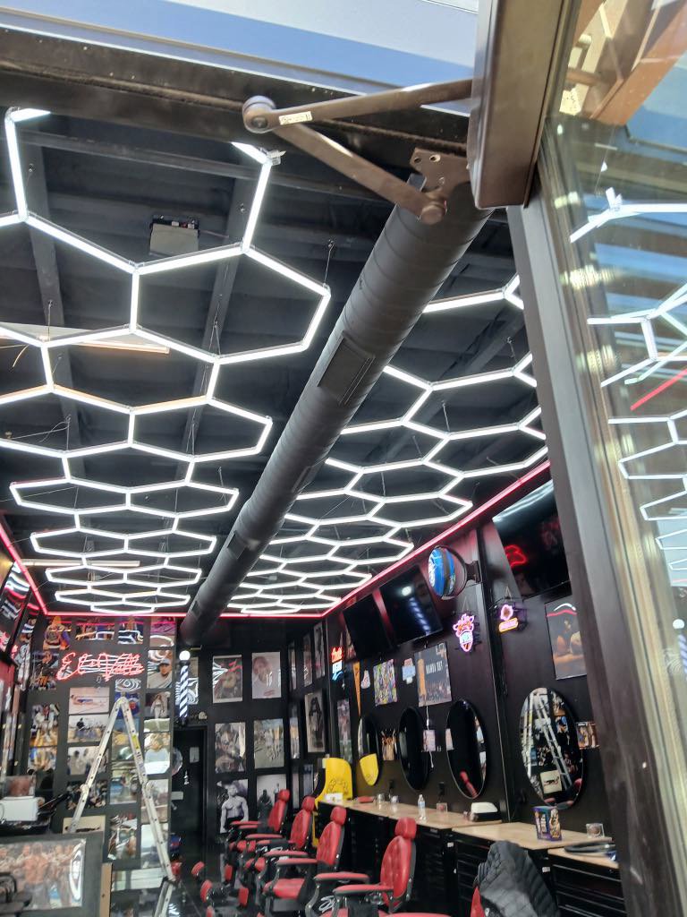 Exposed spiral ductwork for HVAC installed in a modern barbershop by BH cooling & Heating in Glendale, AZ.