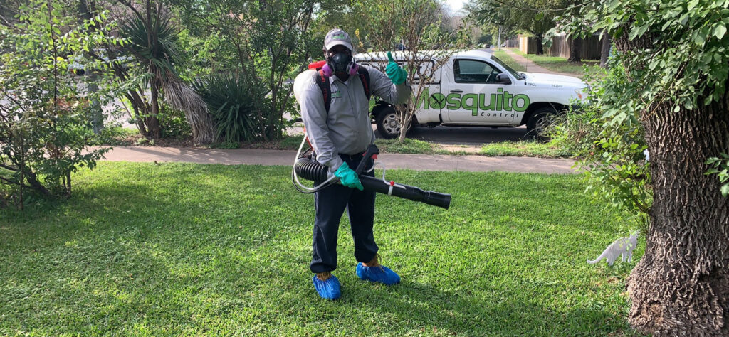 A Barefoot Mosquito & Pest Control technician in PPE with a mist blower, ready for service in Austin, TX.