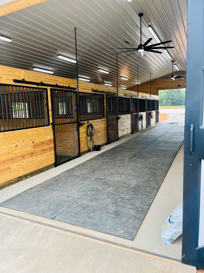 Overhead lighting and large ceiling fans installed in a barn or stable by ELEC LLC in Winston-Salem, NC.