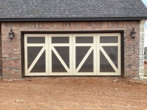 A barn-style garage door installed on a new construction home by CCM Overhead Doors in Oklahoma City, OK