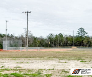 A chain link backstop and outfield fence installed at a baseball field by Precision Fence in Meridian, MS.