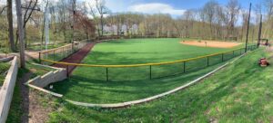 A baseball field enclosed by a durable chain-link fence installed by Integrous in Gap, PA