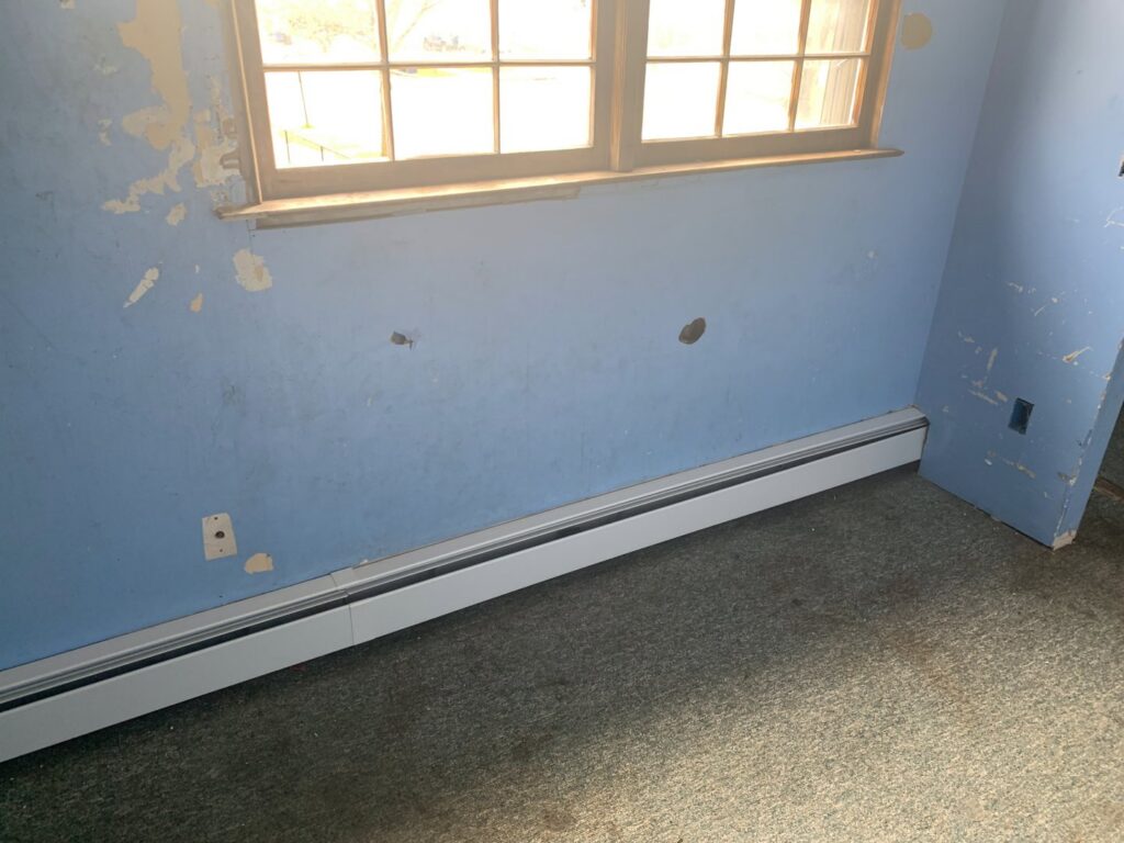 New baseboard heating units installed in a room by Hyper Fusion Heating & Cooling in Waterbury, CT.
