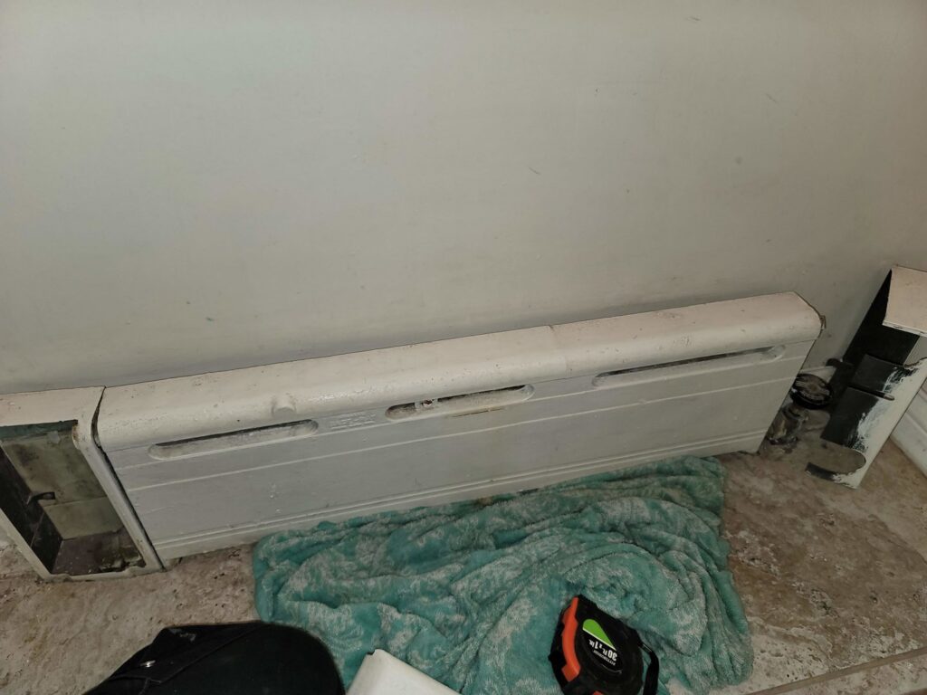 A baseboard heating unit, indicating heating system service by HVAC Royal Service Inc in Chicago, IL.