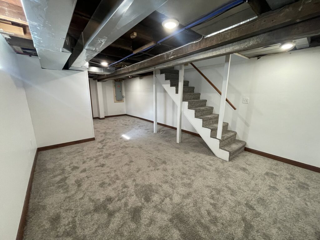 New carpet installed in a finished basement with carpeted stairs by Rayman Flooring in Aberdeen, SD