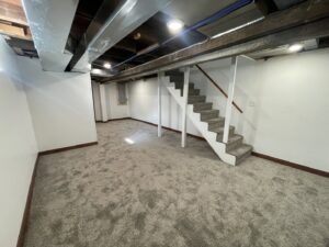 New carpet installed in a finished basement with carpeted stairs by Rayman Flooring in Aberdeen, SD
