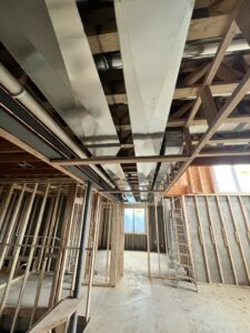 Large rectangular ductwork installed in the basement of a new construction home by Adam's HVAC in Naperville, IL.