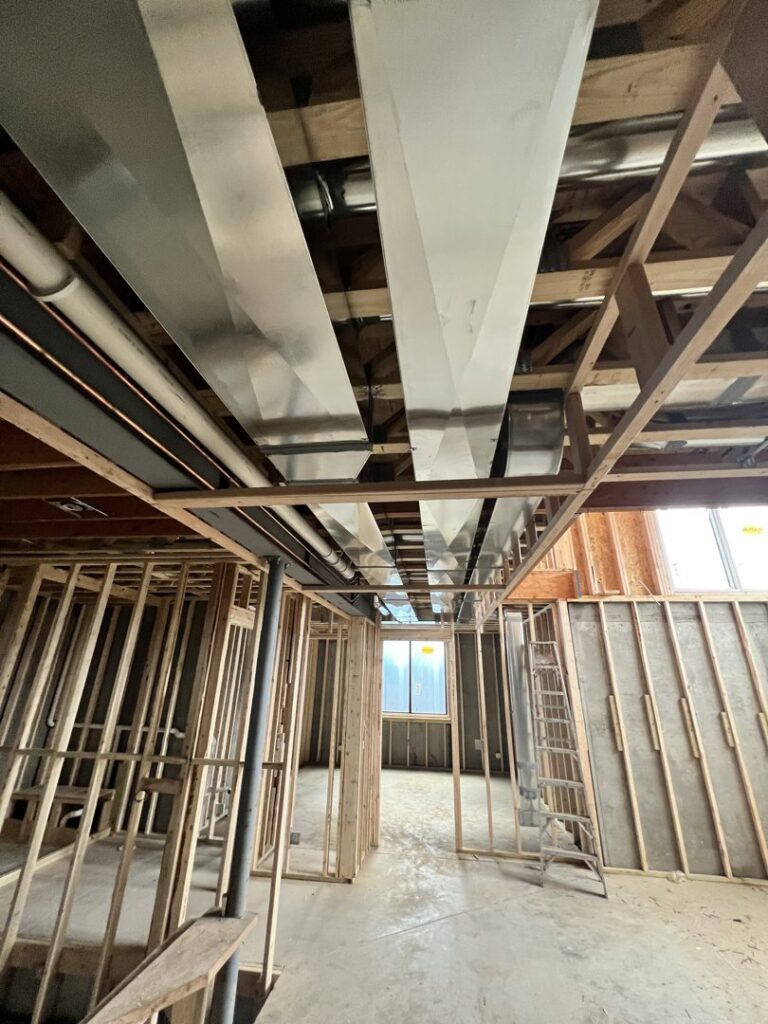 Large rectangular ductwork installed in the basement of a new construction home by Adam's HVAC in Naperville, IL.