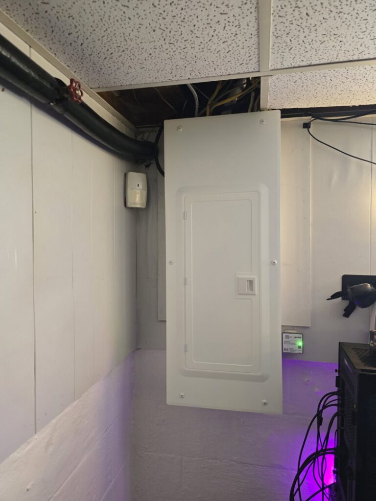 An electrical panel installed in a finished basement area by Be Bright Electric in Erie, PA.