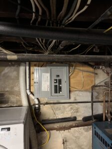 An electrical panel installation in a basement utility room by MV Electrical LLC in Phoenix, AZ.