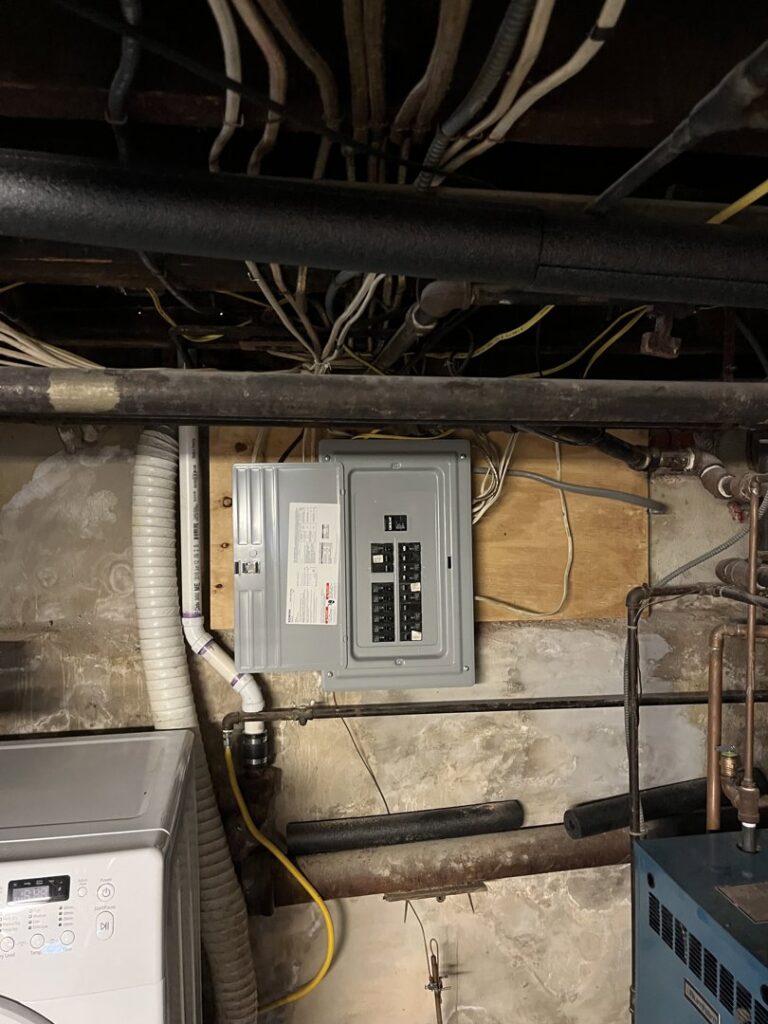 An electrical panel installation in a basement utility room by MV Electrical LLC in Phoenix, AZ.
