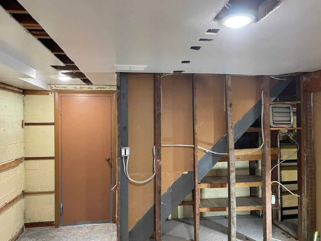 Basement electrical rough-in with exposed wiring and recessed lighting installation by Ruben's Electric in Harlingen, TX