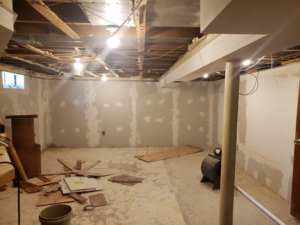 Basement renovation showing exposed electrical wiring and temporary lighting installed by BMB ELECTRIC LLC in Columbus, OH.