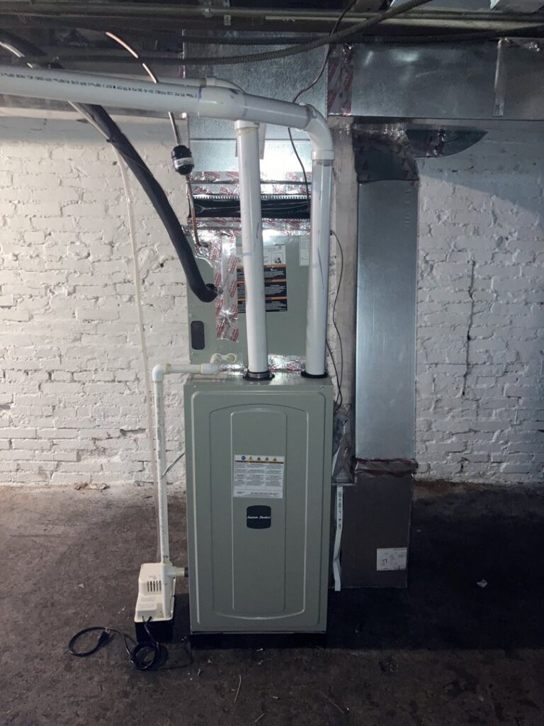 A new furnace or air handler unit with associated ductwork and piping installed in a utility room by Tack Mechanical LLC in Baltimore, MD.