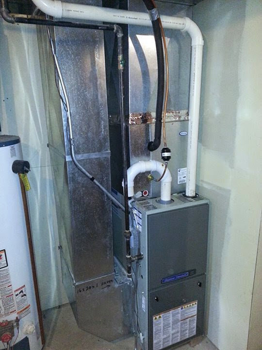 A furnace and ductwork system in a basement by Complete Comfort Heating & Cooling in Kenosha, WI.