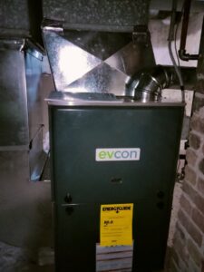 A furnace unit with ductwork installed in a basement by Bean'z Heating and Cooling in Chicago, IL.