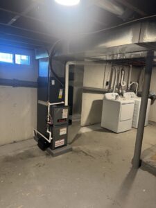 A furnace and water heater installed in a basement by Russell Climate Solutions in Schenectady, NY.