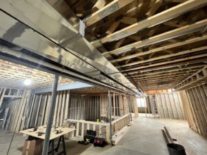 Extensive HVAC ductwork installed in the open ceiling of a new construction basement by Adam's HVAC in Naperville, IL.
