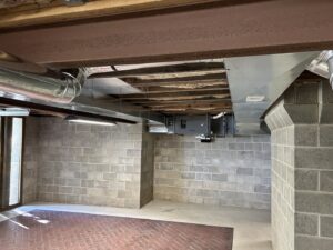 Newly installed HVAC ductwork and an air handler unit in a basement by Cool Tech Heating & Cooling in East Peoria, IL.