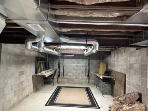 Newly installed HVAC ductwork in a residential basement by Cool Tech Heating & Cooling in East Peoria, IL.