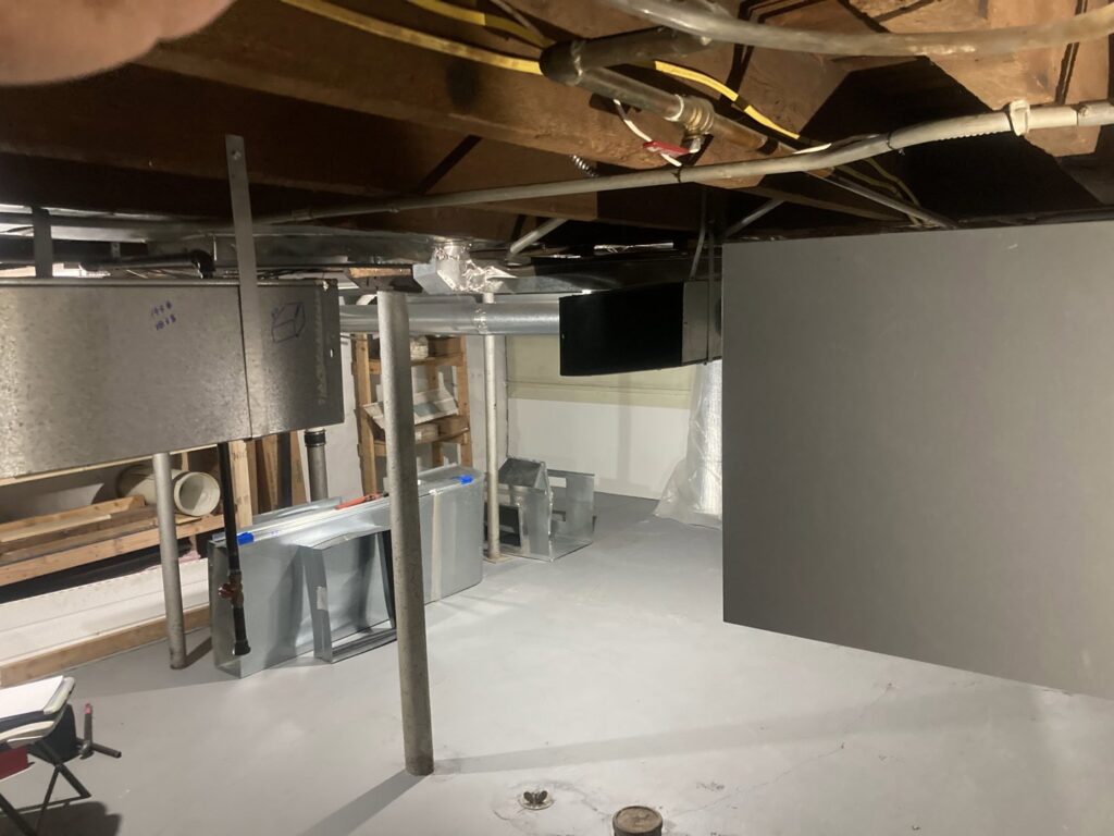 A basement showing new HVAC ductwork installation in progress by Manny Services in Syracuse, NY.