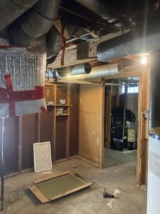 Basement area showing existing HVAC ductwork as part of a system serviced by Manny Services in Syracuse, NY.