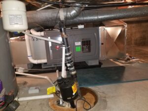 A basement view of an HVAC furnace, ductwork, and water heater, representing services by Peterson Heating & Cooling in Mound City, KS.