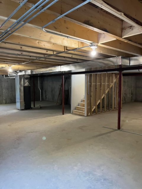 HVAC system and ductwork in a residential basement by DJ's Heating & Air Conditioning in Wilmington, IL.