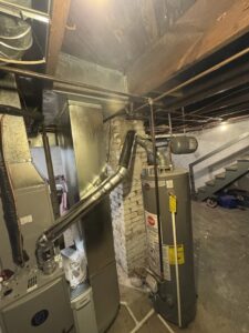 A complete basement HVAC system including a furnace, water heater, and extensive ductwork, installed by Lopez Mechanical HVAC in Kansas City, MO.