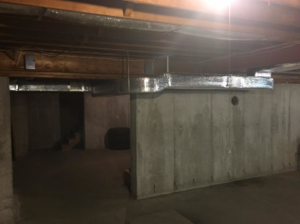 Insulated ductwork installed along the ceiling of a basement by R&M Mechanical Services LLC in Milford, CT.