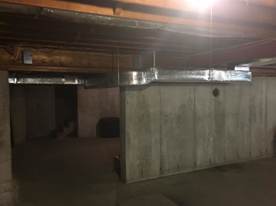 Insulated ductwork installed along the ceiling of a basement by R&M Mechanical Services LLC in Milford, CT.