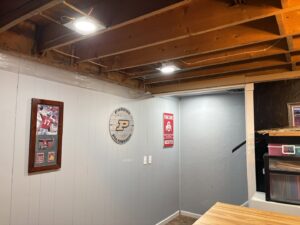 Basement ceiling with exposed wiring and newly installed recessed lighting by Sterling Electric in Fort Wayne, IN.