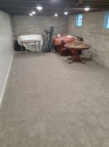 A finished basement room with new carpet installed by Blue Star Flooring in Euless, TX