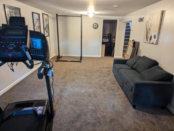 A finished basement room with durable grey carpet, perfect for a home gym or living area, installed by Floors By Tomorrow in Aurora, CO