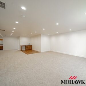 A large basement room showcasing new light-colored carpet installed by IDF The Floor Store in Idaho Falls, ID.