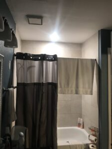 A bathroom with a bright ceiling light fixture installed by Christensen Electric in Galveston, TX.