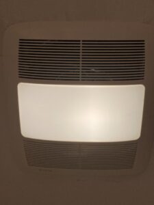 A modern bathroom exhaust fan with an integrated light, expertly installed by Rylix Electric in Cincinnati, OH.