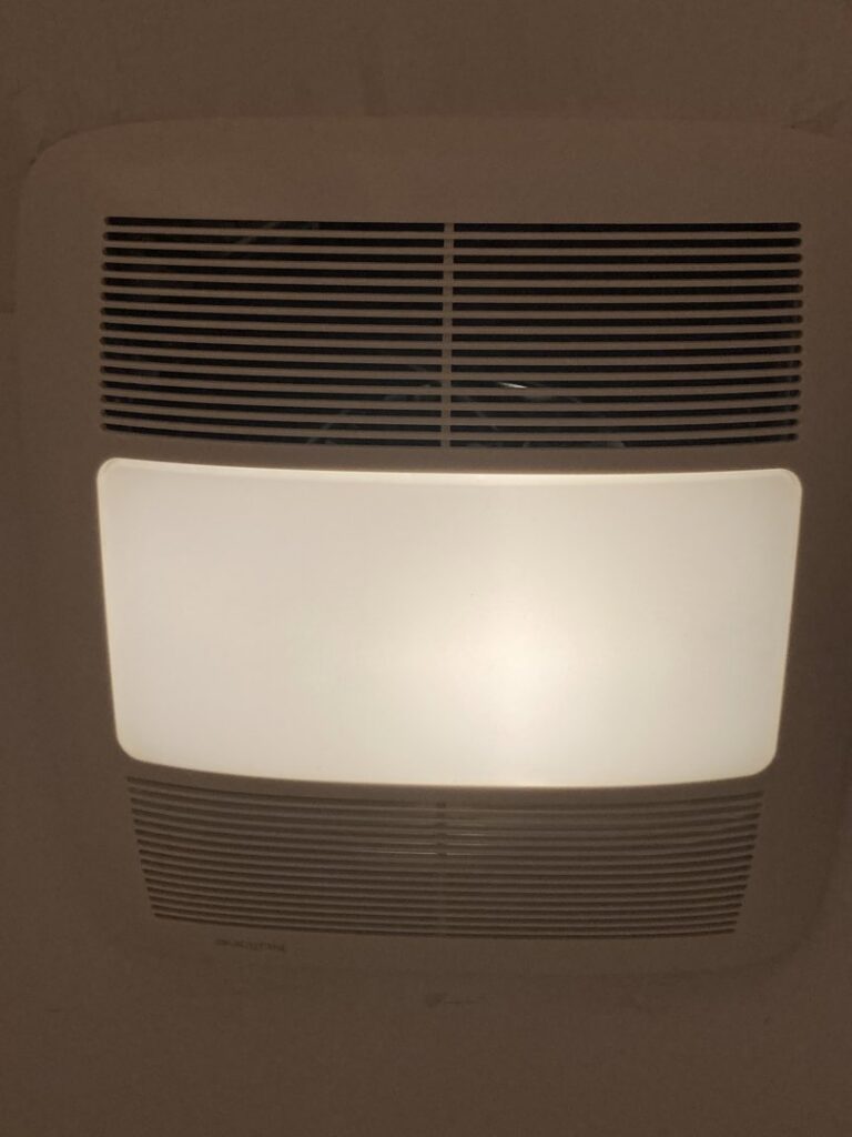 A modern bathroom exhaust fan with an integrated light, expertly installed by Rylix Electric in Cincinnati, OH.
