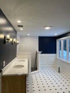 A bathroom featuring new wall sconces, recessed lighting, and an exhaust fan installed by EPOS Systems, Inc. in West Springfield, MA.