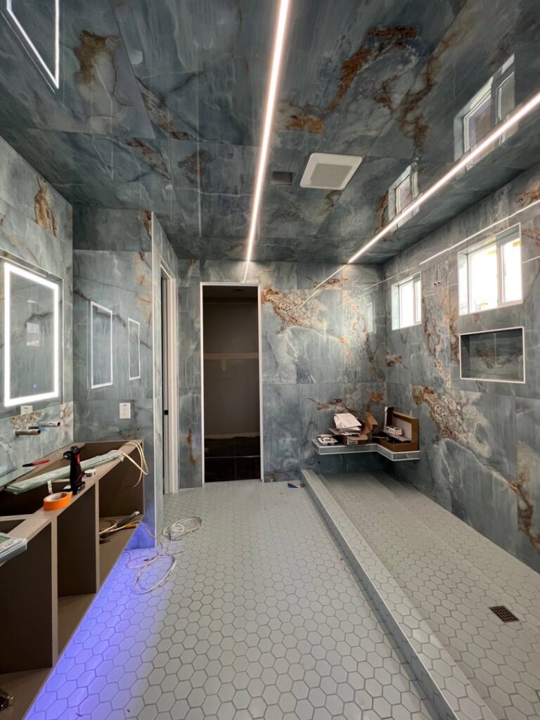Bathroom under construction with LED strip lighting and illuminated mirrors being installed by Gilmore Electrical in Saint Louis, MO