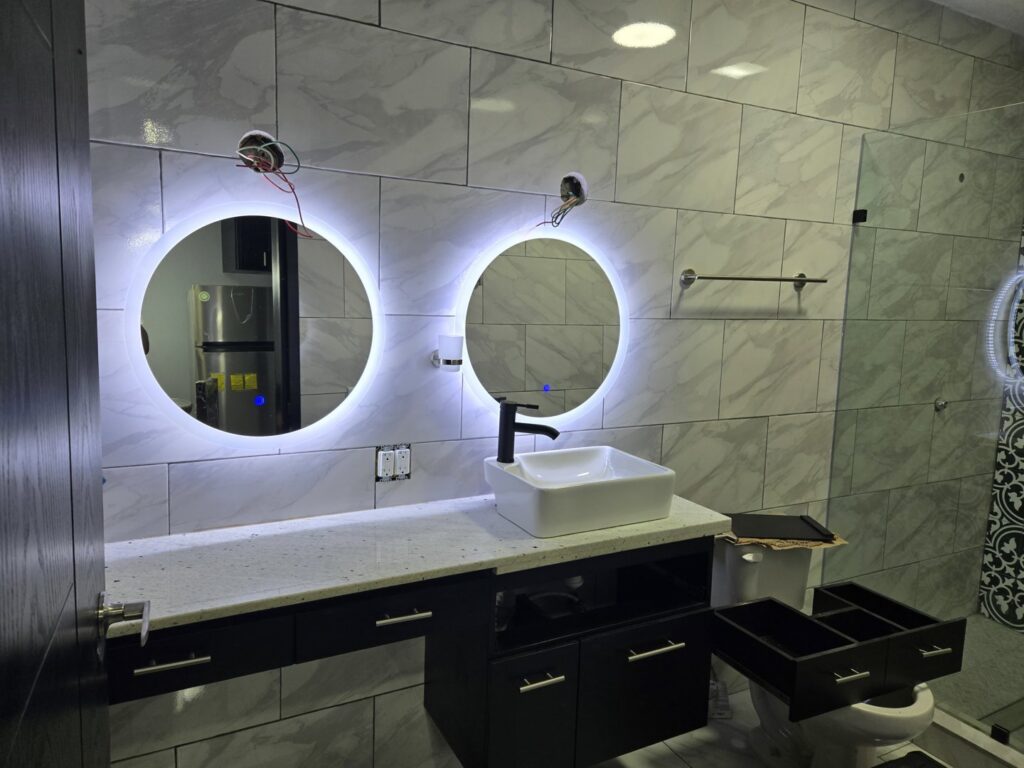 Modern bathroom lighting and illuminated mirror installation by JAL Electrical Construction in Hammond, IN.