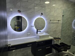 Modern bathroom lighting and illuminated mirror installation by JAL Electrical Construction in Hammond, IN.