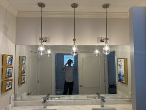 Three stylish pendant lights installed over a bathroom vanity by McCurley Electric, serving Little Rock, AR.
