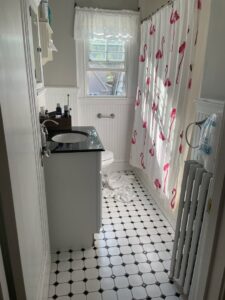 A bathroom with a white radiator, part of a heating system installed by Tony Marzano Plumbing & Heating LLC in Hartford, CT.